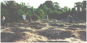 Looters pits at Phnum Snay. Before this massive Iron Age site could be properly documented, much of its context and content had been obliterated by local villagers scouring for artefacts to sell. (Source: http://www.otago.ac.nz/Anthropology/Angkor/-snay.html)