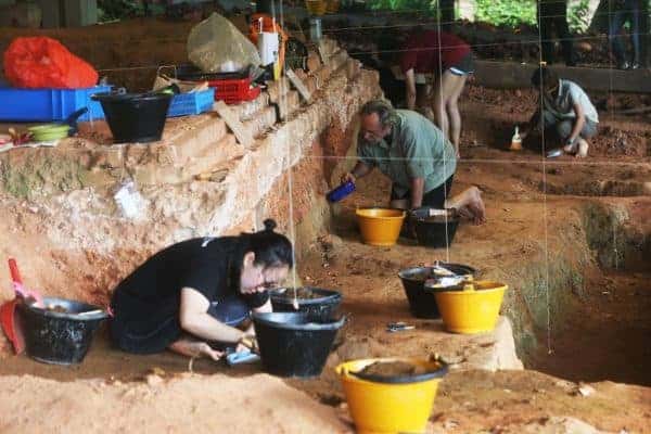 Invited archaeologist Dr John N. Miksic (centre) and volunteers working at the Archaeological dig exhibition at Fort Canning Park on Oct 28, 2018. Photo: Ooi Boon Keong/TODAY